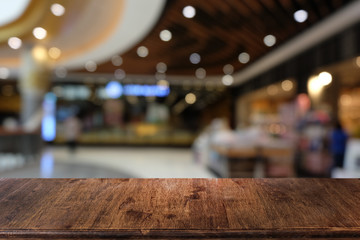 Empty dark wooden table in front of abstract blurred bokeh background of restaurant . can be used for display or montage your products.Mock up for space.