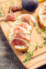 Sandwich with figs, cheese, honey and thyme. Selective focus. Shallow depth of field.