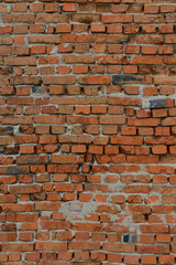 Vertical photo of an old red brick wall