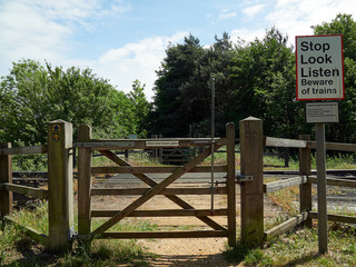 Stop Look Listen sign on foot crossing over Felixstowe Branch line to Northern Rail Terminal UK.