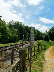 Fototapeta premium View towards Northern Rail Terminal at foot crossing with Stop Look Listen sign.