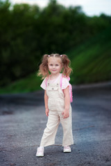 Full-length portrait of a cute girl 3-4 years old in nature.