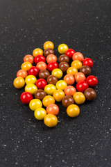 Fototapeta na wymiar Sweet round fall colored chocolate covered candy balls