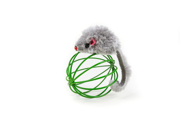 Grey toy mouse playing around a metal cat ball