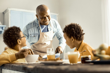 Family laughing at the joke during the morning snack.