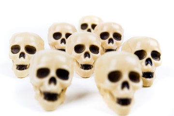 Bone white plastic skull  figures on a blank background
