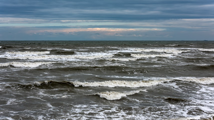 Fototapeta na wymiar Storm at sea, big foamy waves