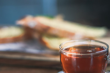 cup of tea at a cafe blurred background and garlic bread.