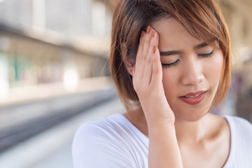 depressed woman suffering from headache, stress, depression, burnout; health care concept