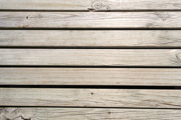 Texture of a wooden planks unpainted natural brown with small gaps