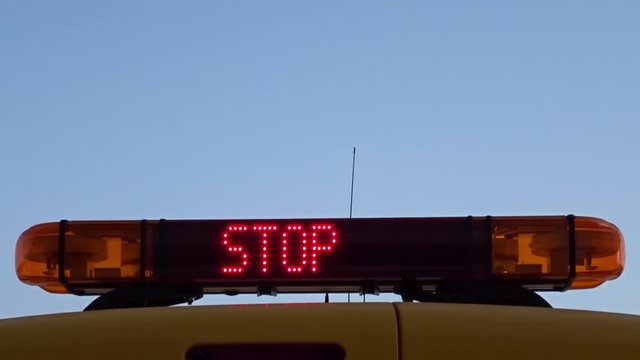 Close up of an airport marshaller sign showing the text "Stop" and "Follow Me". Blank space up left to add a logo or text.
