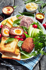 ploughman's lunch on a white platter, top view