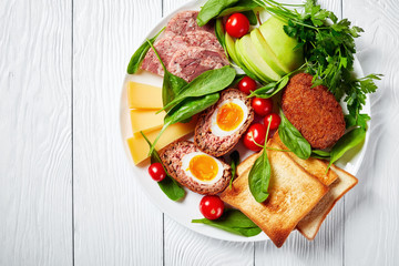 ploughman's lunch on a white plate, top view