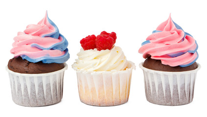 Three tasty cupcakes with cream topping isolated on white