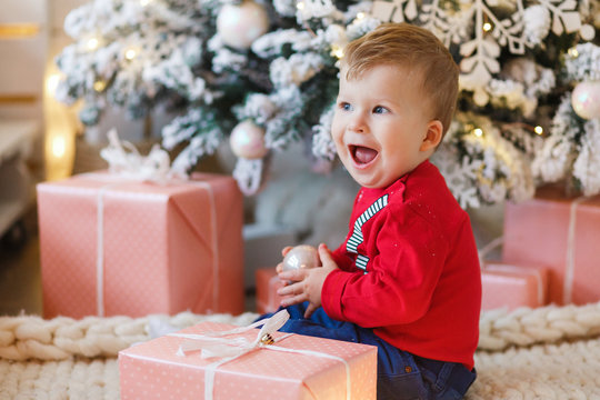 Excited Little Boy Gift Boxes Under Christmas Tree