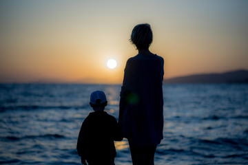 Silhouette of a girl and a boy near the sea