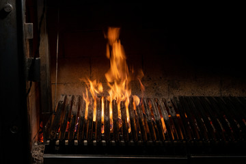 fire burning under a grill