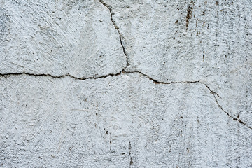 Texture of a concrete wall with cracks and scratches which can be used as a background