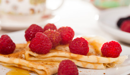 delicious  pancakes with fresh raspberries and honey