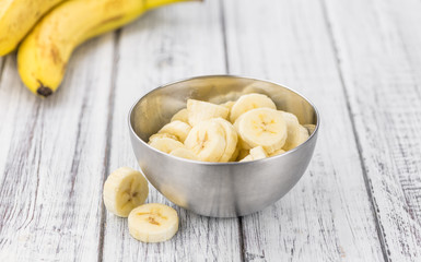 Wooden table with Sliced Bananas, selective focus