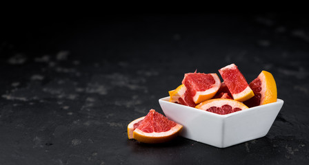 Sliced Grapefruits on a slate slab (selective focus)
