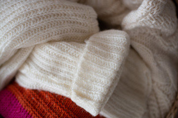 Fototapeta na wymiar basket of woolen clothes. autumn and winter concept