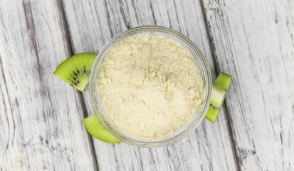 Bowl with fresh made Kiwi powder (selective focus)