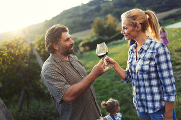 Picture of people tasting red wine in vineyard