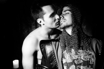 Gay lovers, a shirtless man and knight in full armour, about to kiss