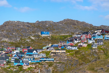 Colored houses on rocky hills in Qaqortoq, Greenland.