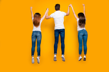 Rear back behind full length body size view of three nice attractive friendly adorable slim fit thin sportive sporty person having fun free time isolated over bright vivid shine yellow background