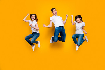 Fototapeta na wymiar Full length body size view portrait of three nice attractive strong sporty satisfied cheerful cheery person having fun celebrating attainment isolated over bright vivid shine yellow background