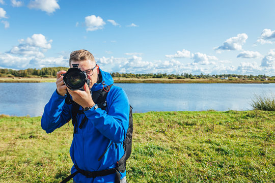 man taking photo with digital camera, professional photographer
