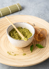 Japanese matcha green tea powder, a healthy natural product, antioxidant. Bamboo spoon and whisk.