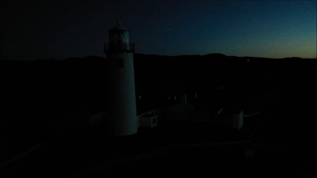 Drone footage of Fanad Head Light house at twilight with planet Jupiter on view,