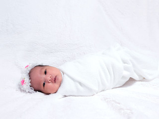 little girl on white blanket