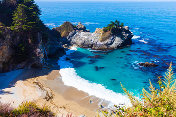 Stunning view of McWay falls on the coast of Big Sur in central California that flows year-round...