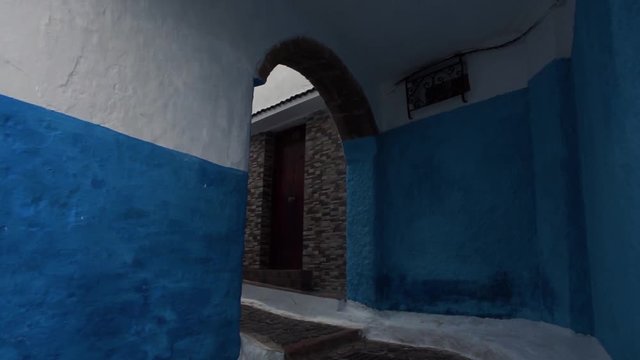 walking in a lane inder an ancient building in the Kasbah of oudayas, Rabat, Morocco