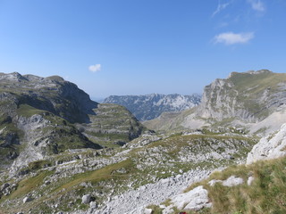 Fototapeta na wymiar A mountain valley with the surrounding mountain range