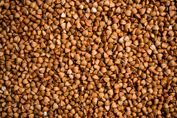 The texture of dry buckwheat. Background image of buckwheat porridge. Maro's Photo