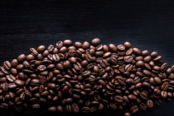 Coffee beans on wooden background.