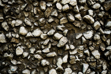 Texture photo of rough concrete plaster with sprinkled gravel