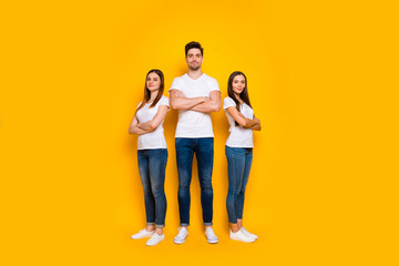 Fototapeta na wymiar Full body photo of charming people with their arms crossed looking wearing white t-shirt denim jeans isolated over yellow background