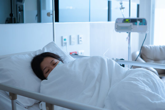 Asian female patient sleeping on hospital bed to recovering sickness, healthcare and medical concept - image