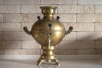 Beautiful vintage russian samovar on the brick background