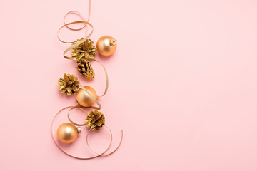 New Year or Christmas layout balls serpentine cones of gold color on a pink background. Holiday...