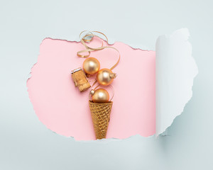 Ice cream waffle cup Christmas balls serpentine cork from bottle of gold color paper hole mint color. New Year concept.