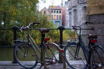 Fototapeta na wymiar Ghent, Belgium; 10/29/2018: Rear part of two classic comfort bikes parked with a defocused background