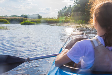 Travel Concepts. Caucasian Girl Kayaking With  Paddle On River In Summer Outdoors.