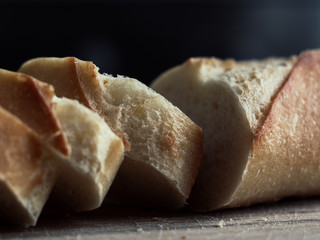 Fresh baked rye bread and sliced bread on rustic wooden board. Closeup.
